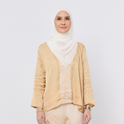 Woman wearing a beige outfit with a white hijab on a plain background