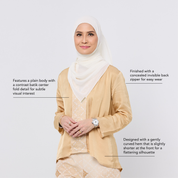 Woman wearing a beige blouse with a white hijab on a light gray background