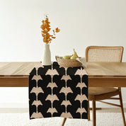 Handcrafted black batik table runner in the pattern black coconut with coconut motif on a wooden dining table