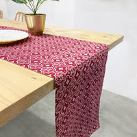 a lifestyle photo of table runner hanging by the edge of dining table