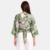 Woman facing the back wearing green tie front kimono