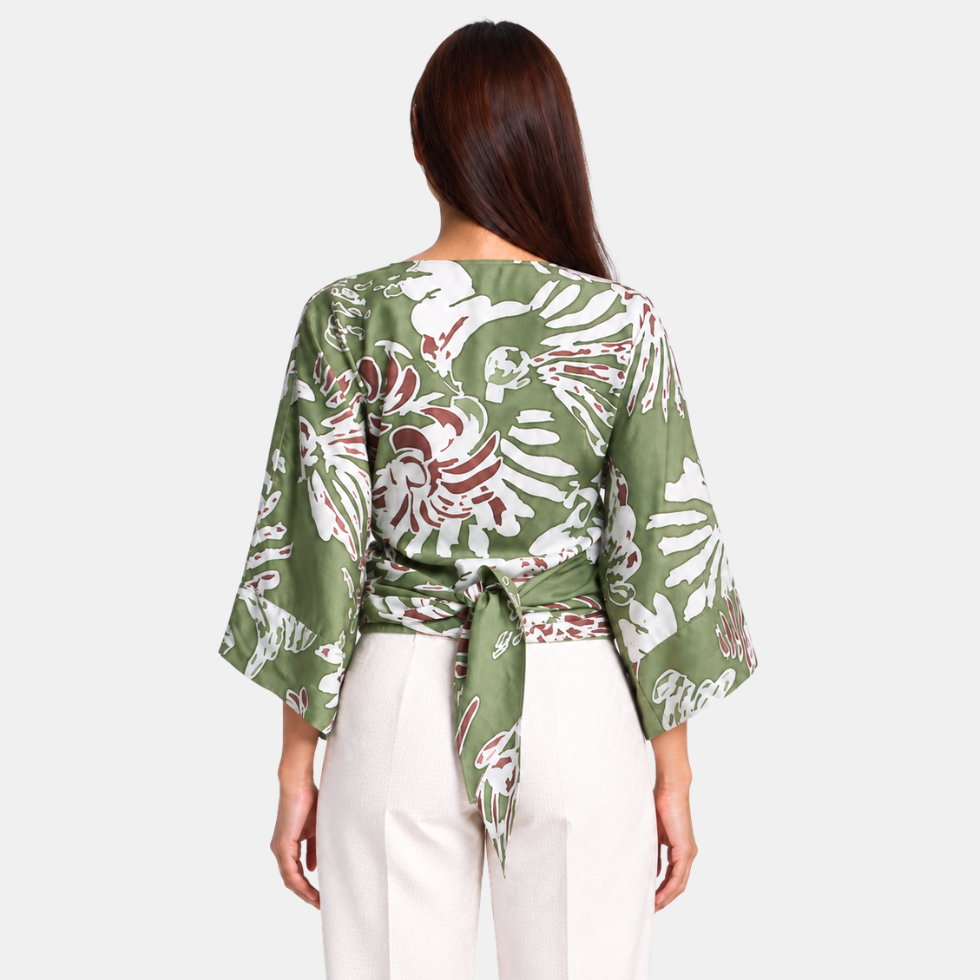 Woman facing the back wearing green tie front kimono