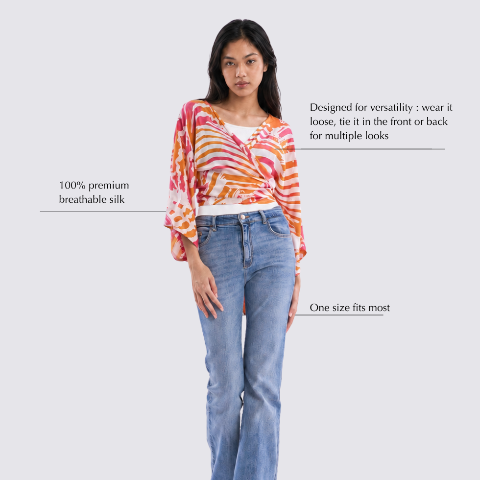 Woman wearing a colorful top and blue jeans on a white background