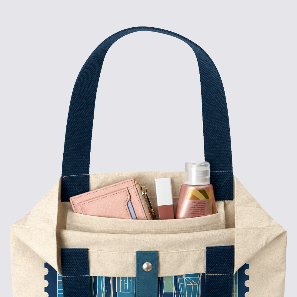 Closeup of totebag with blue-ish KL inspired prints, and products inside