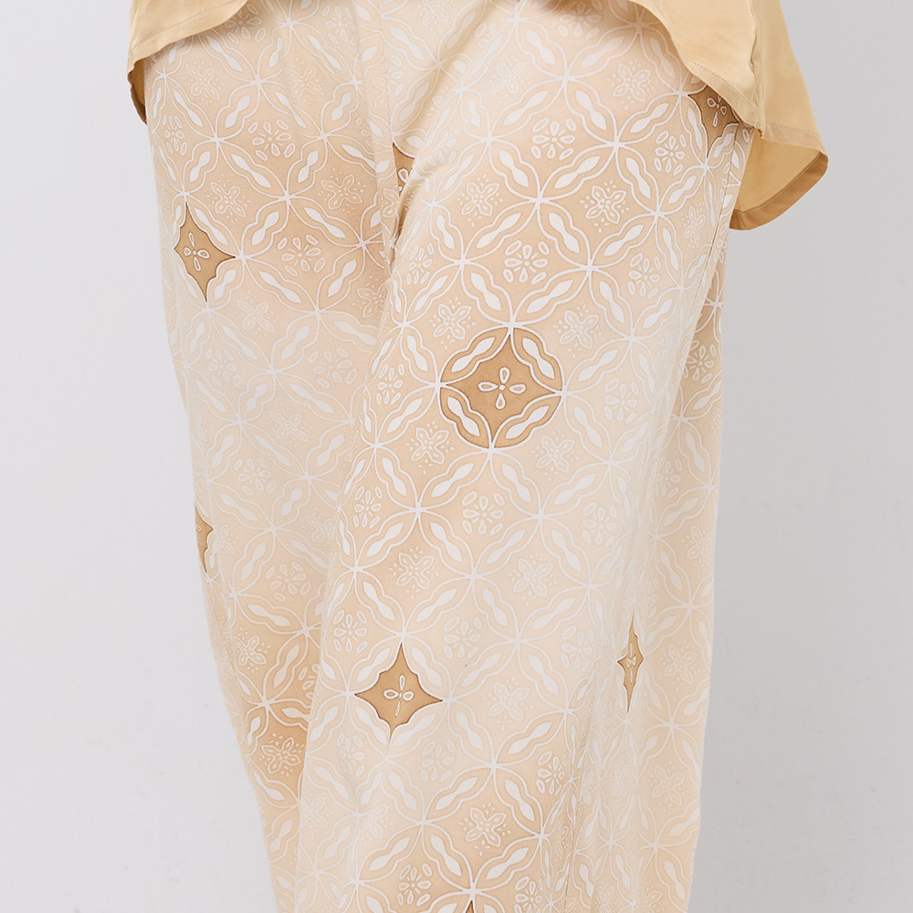 Beige embroidered garment on a plain background