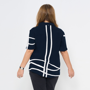 the back of a batik cuban for women against a white background in the pattern navy brush