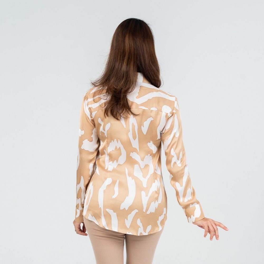 Back view of a woman wearing a long-sleeved batik shirt in Tan Rimba print, showcasing a flowy and breathable silhouette with a jungle-inspired motif