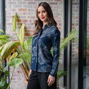 a woman posing in a batik shirt in the pattern navy orchid in a lifestyle background