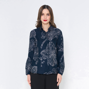 a woman posing in a batik shirt in the pattern navy orchid