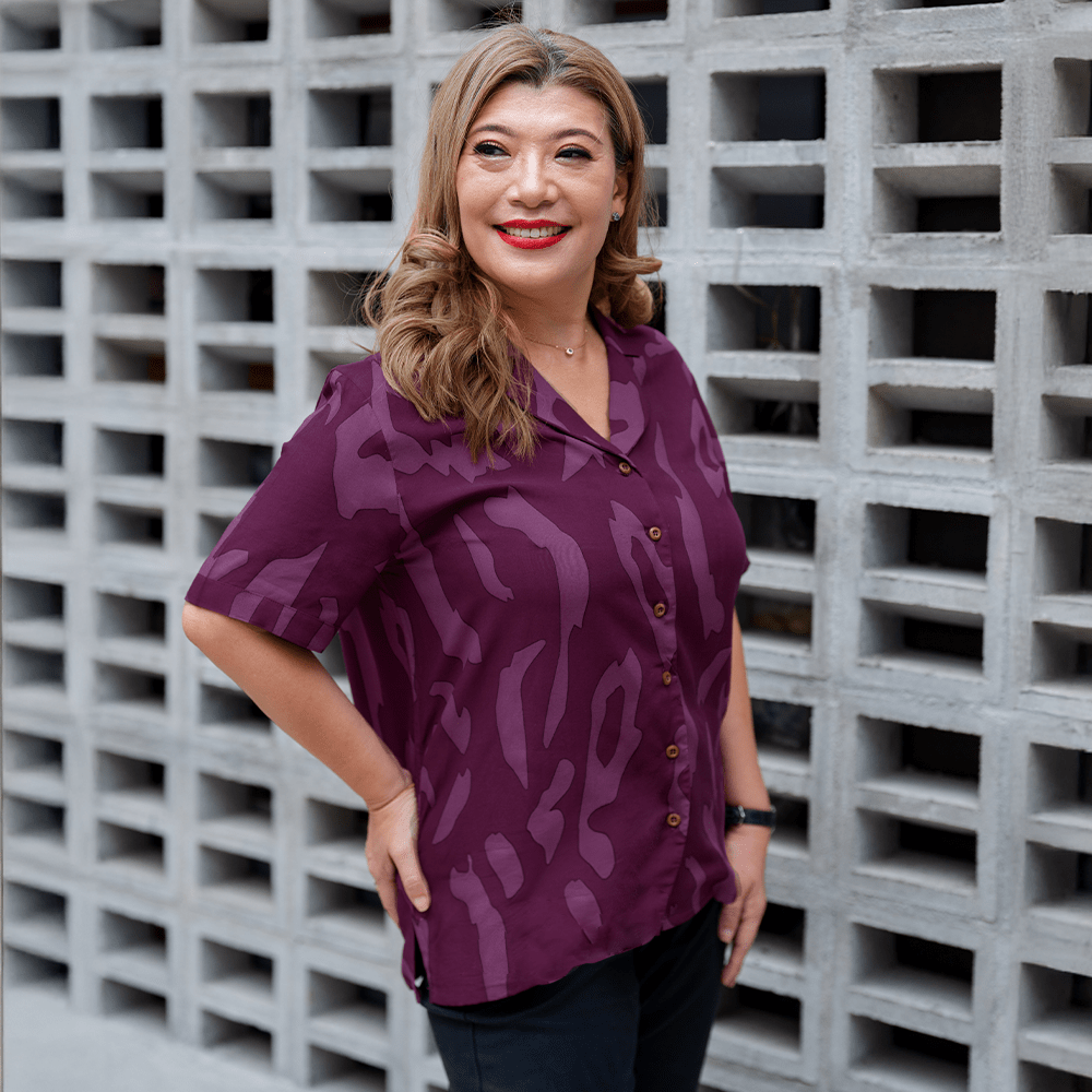 a woman posing in a lifestyle photo in a batik shirt in the pattern purple rimba