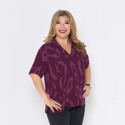 a woman wearing batik cuban shirt in plum rimba against a white background