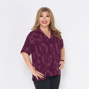 a woman wearing batik cuban shirt in plum rimba against a white background