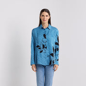 Front facing photo of the Azure blooming lace showing the long sleeves buttons ups and collard with the black florals design on the lattice 