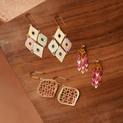 Set of geometric earrings on a wooden surface