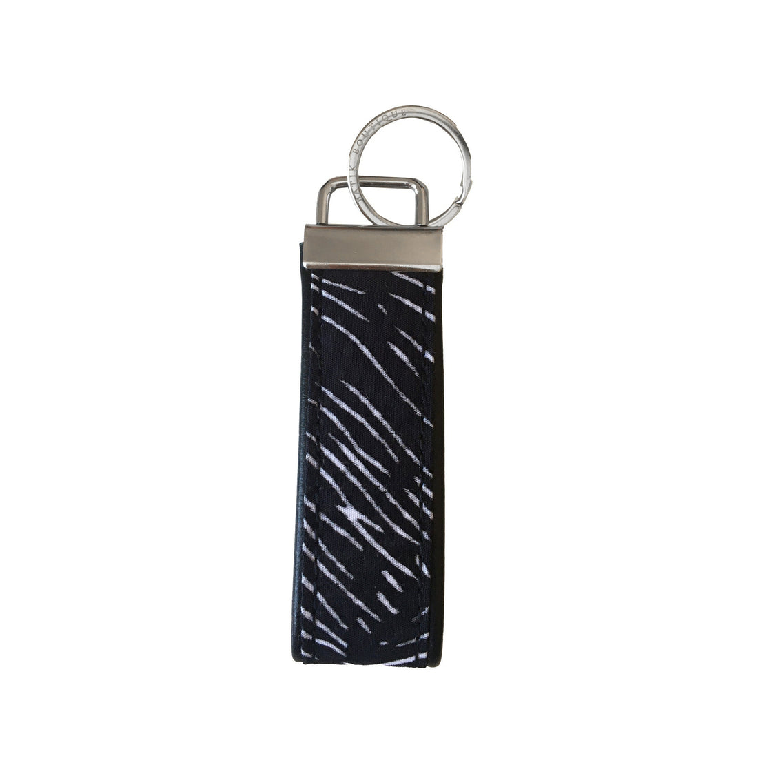 A frontside photo of batik key fob in black driftwood pattern on a white color background