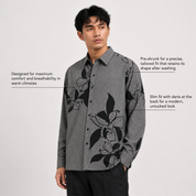 Man wearing a gray floral shirt on a white background
