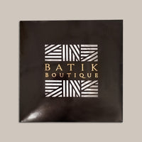A black box coated in glossy material. With Batik Boutique logo. Showing frontside of it