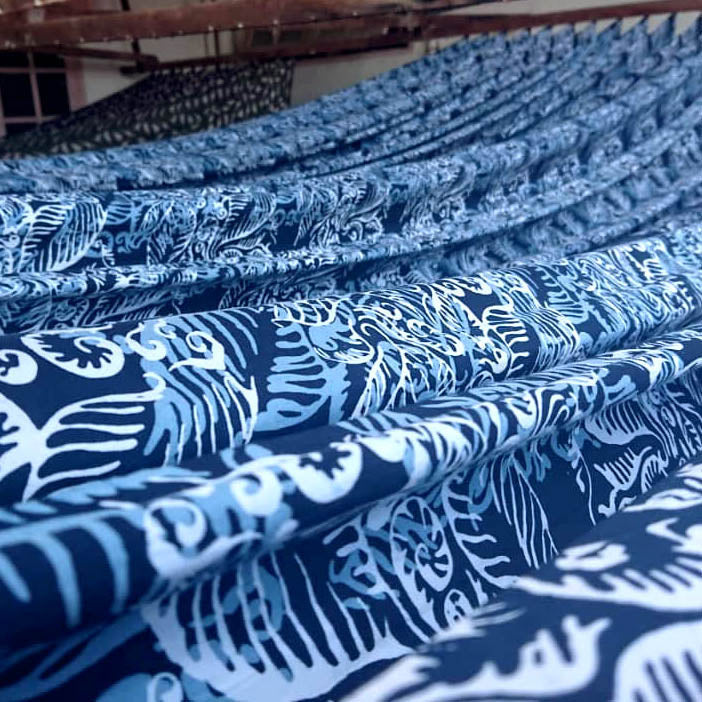 a photo of batik fabric in blue nautical fern pattern hang to dry it
