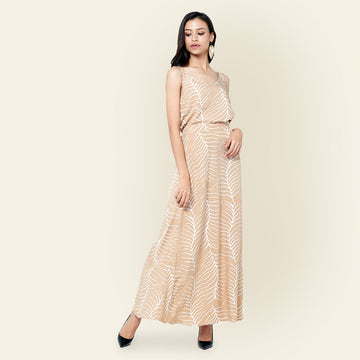 a photo of woman standing in front of beige background styling batik skirt and camisole in latte fern] print