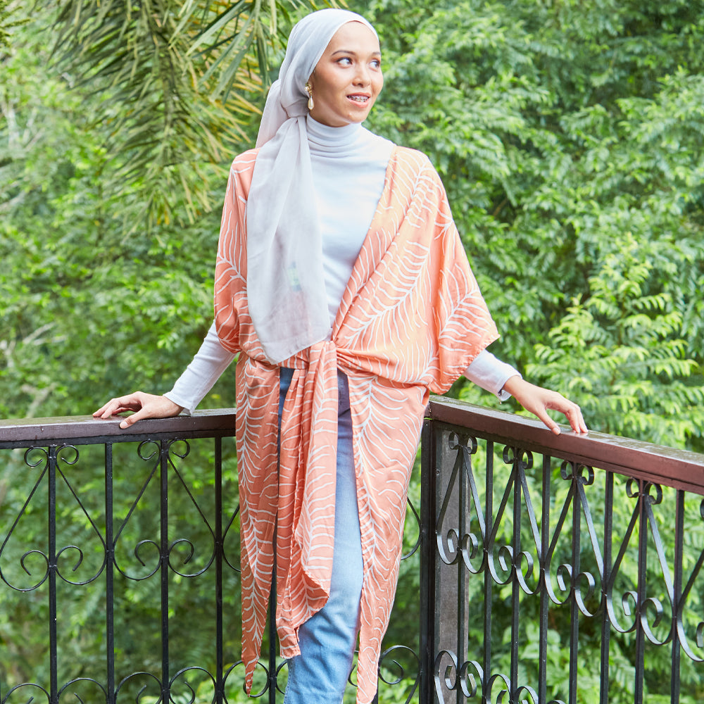 Muslim woman wearing batik kimono in peach Fern hand printed in Malaysia.