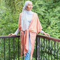 Muslim woman wearing batik kimono in peach Fern hand printed in Malaysia.