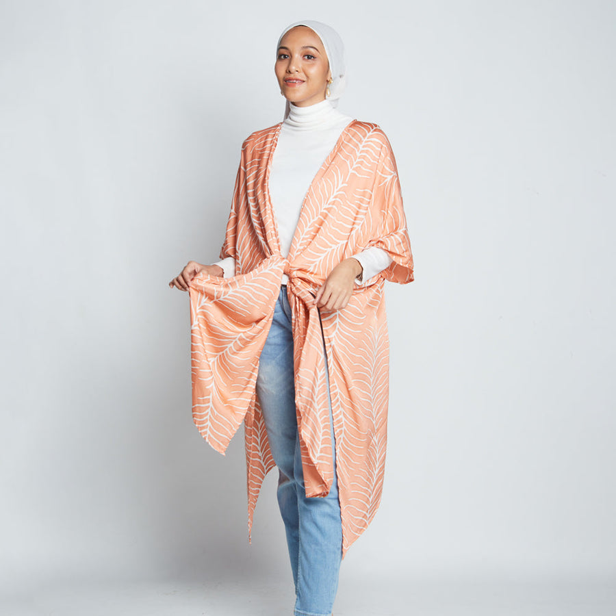 Muslim model posing wearing batik kimono in peach Fern hand printed in Malaysia.