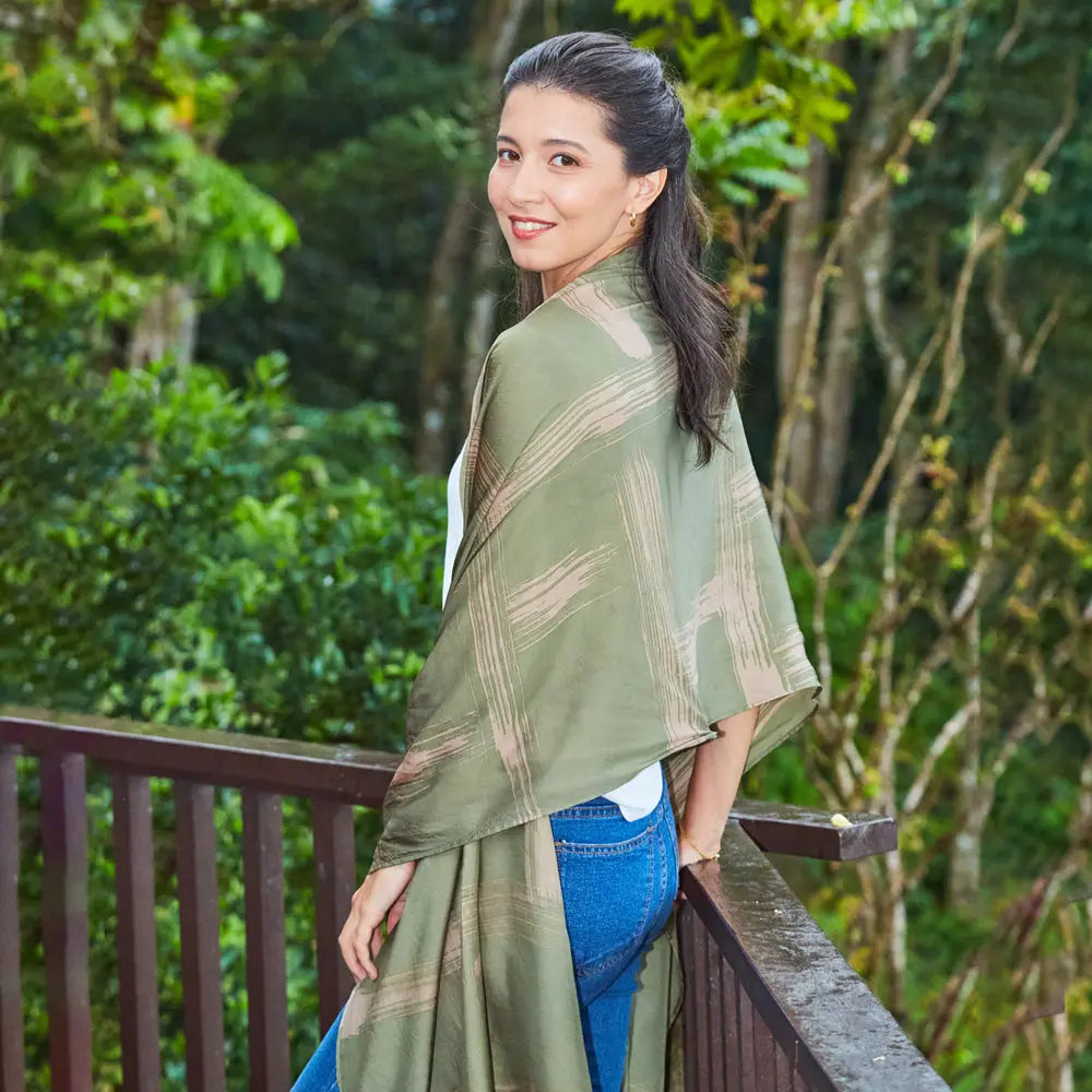 Women at a jungle resort wearing shibori scarf in olive color combinations, handprinted in Malaysia.