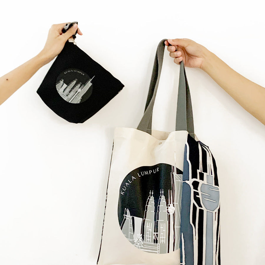 a showcase of all the items in the kl skyline collection including a pouch, a scarf and a tote bag all in the color jet arang