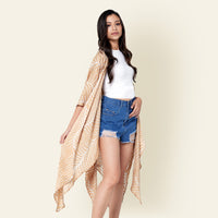 Model posing with batik long Kimono in Latte Fern and short jeans, using traditional Malaysian printing method.