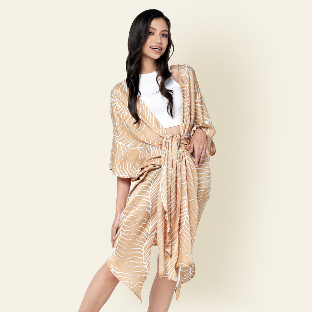 Model posing with knotted batik long Kimono in Latte Fern, using traditional Malaysian printing method.