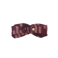 a back view of a batik headband in the pattern crimson arrow in a white box style 