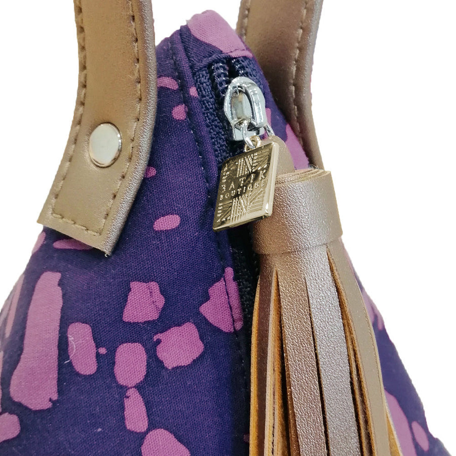 a closeup photo showcasing the details on the bag made of batik in the pattern purple bintik