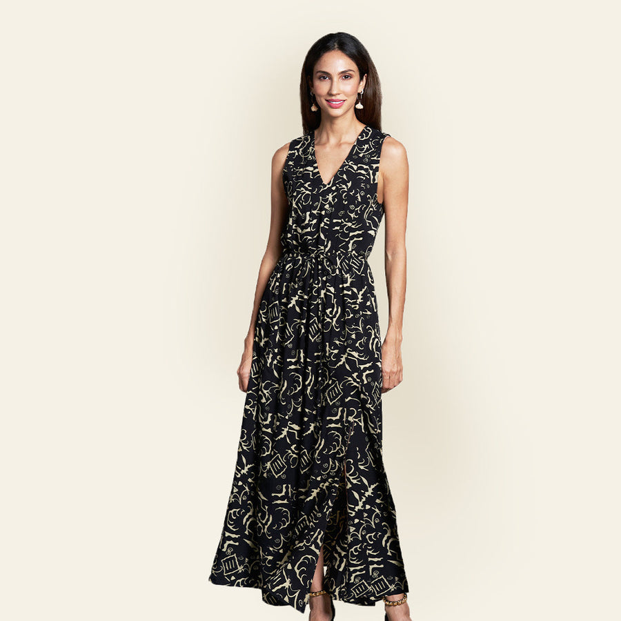 Woman posing in front the camera in her batik maxi dress in black diwanie print, handcrafted in Malaysia.