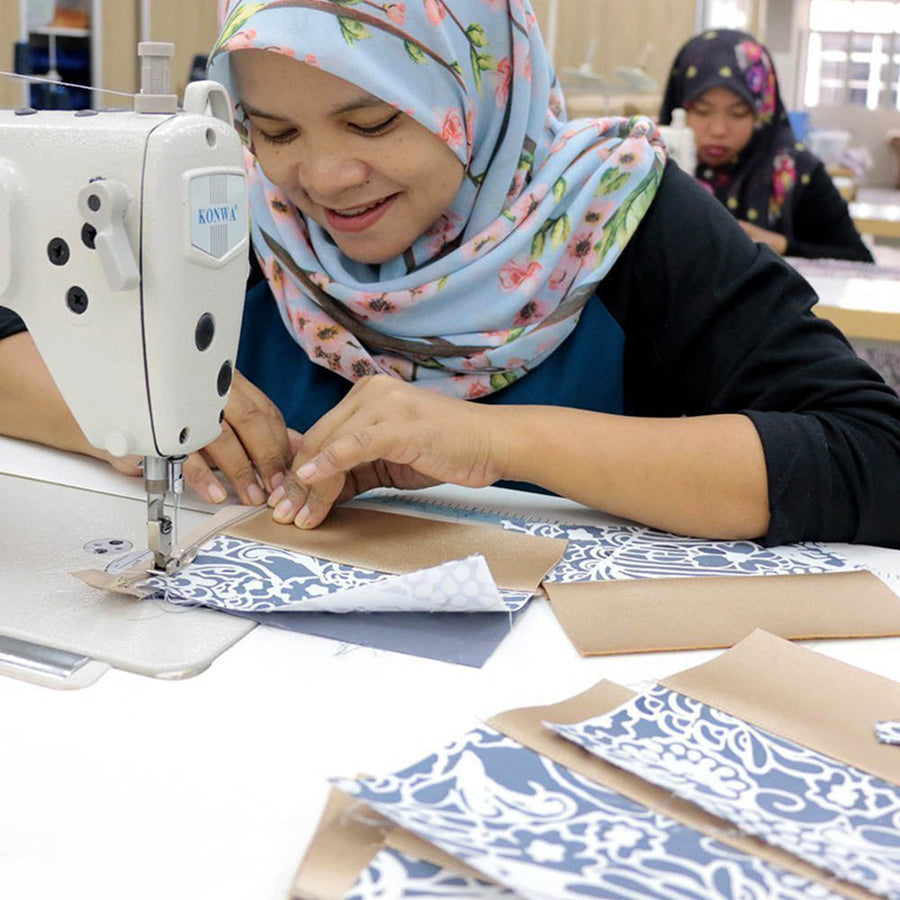 a seamstress sewing batik zip pouch
