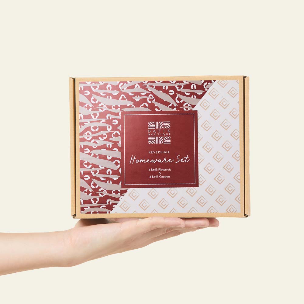 a white box photo of a box that's perfect for gifting homeware set in the pattern crimson tiger against a neutral background with a hand holding the box up