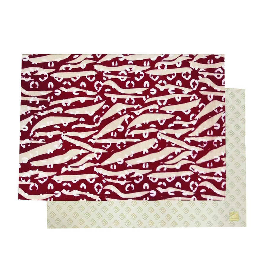 a white box photo of two placemats in the pattern crimson tiger