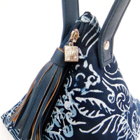 a close up photo of a bag made of batik in the pattern blue nautical fern in front of a neutral background