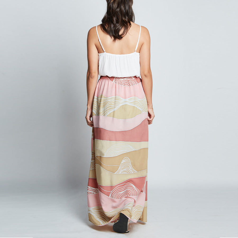 Back view of pink batik long flare skirt with elastic waist and hidden zip in Dawn Bukit print.