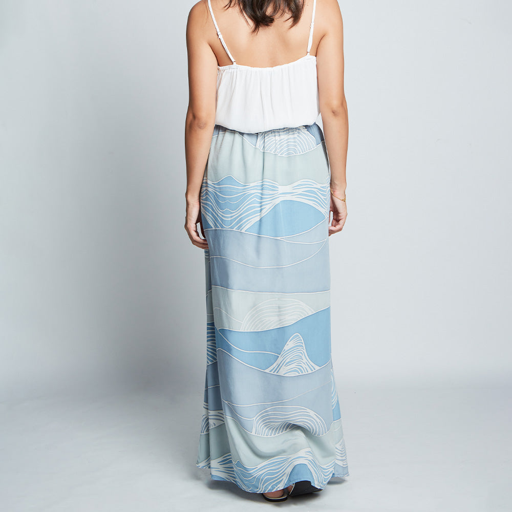 Back view of blue batik long flare skirt with elastic waist and hidden zip in Sky Bukit print.