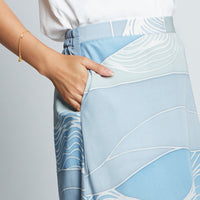 Closeup of blue batik long flare skirt with flat front and pocket on side from Raya 2023 collection at Batik Boutique.