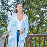 Lifestyle shot of woman in blue Sky Bukit batik kimono from Batik Boutique inspired by Malaysia's hills.